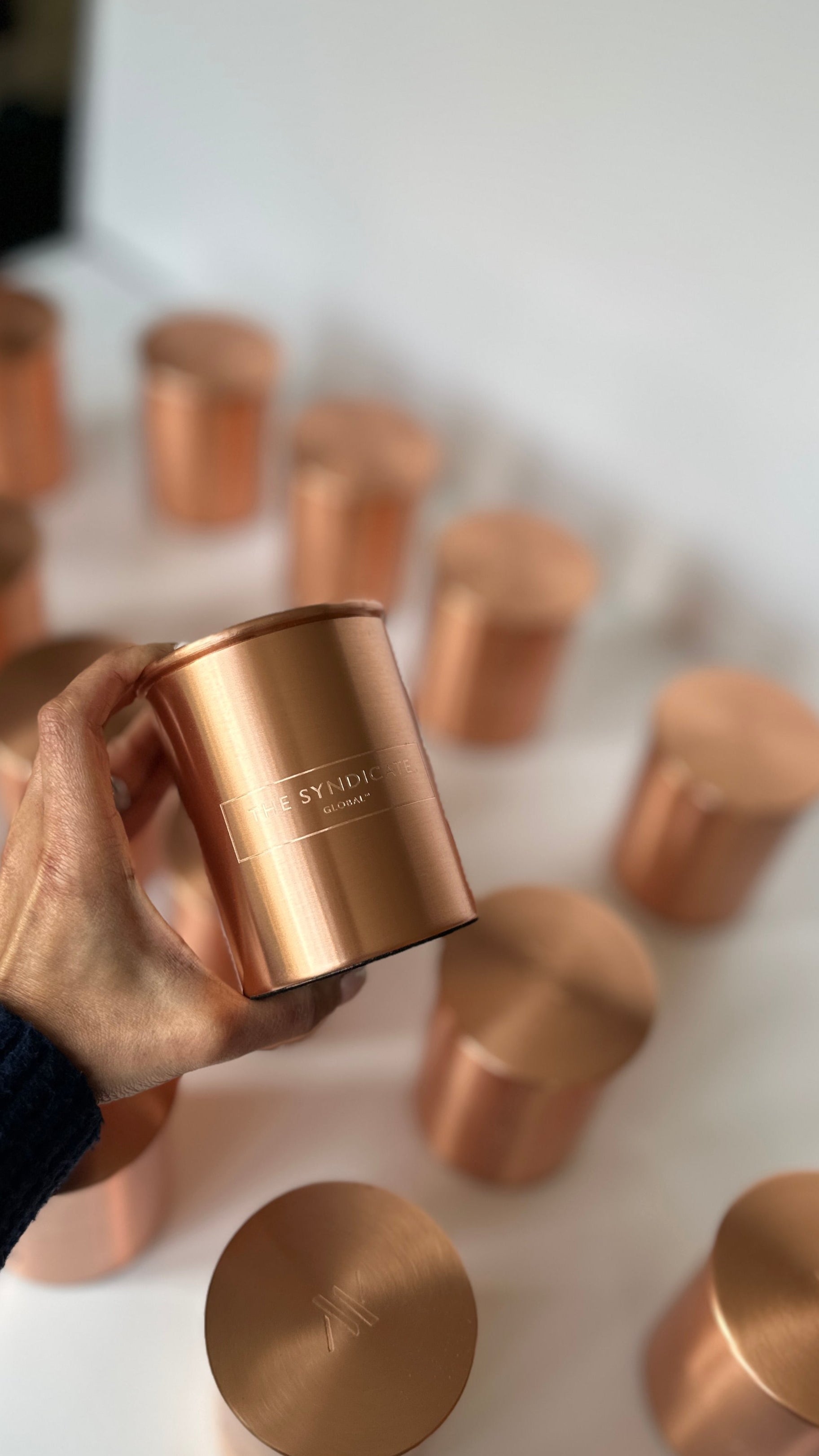 Hand holding a Copper Personalised corporate gift with a personalised brand logo 